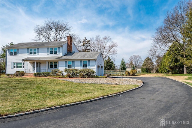 31 Riverview Ter, Hillsborough, NJ 08844 - view of front of home featuring a chimney, asphalt driveway, a porch, and a front yard