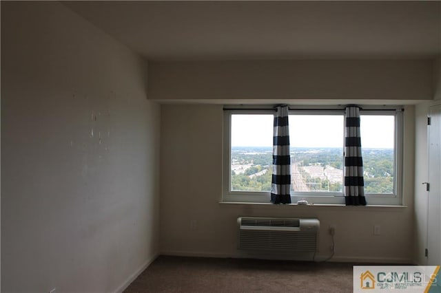 spare room with a wall unit AC and carpet