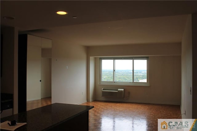 interior space with light parquet flooring and a wall unit AC