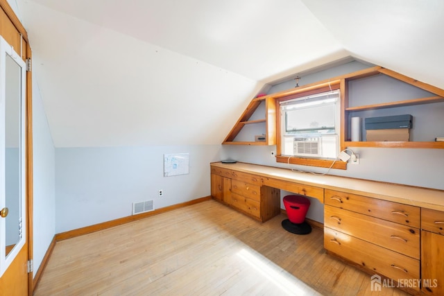86 Lawrence St, Fords, NJ 08863 - bonus room featuring built in study area, lofted ceiling, light wood finished floors, and cooling unit