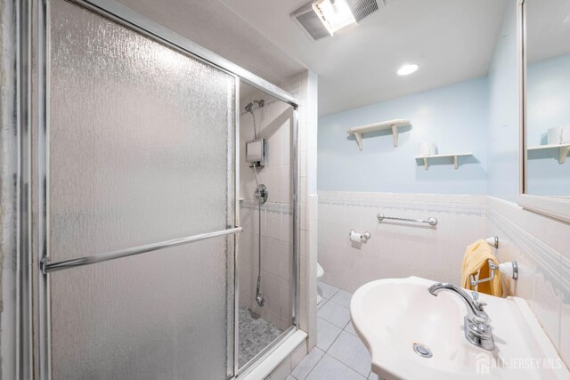 86 Lawrence St, Fords, NJ 08863 - full bath with a stall shower, tile walls, tile patterned floors, and wainscoting