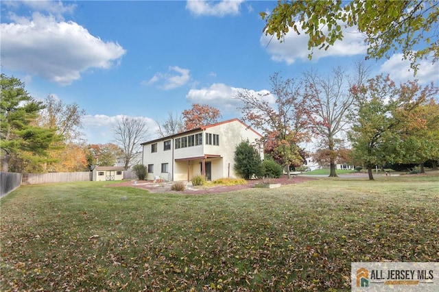 view of front of property featuring a front lawn and a patio