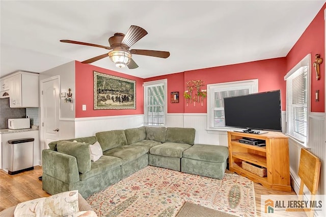 77 Navesink Ave, Middletown, NJ 07748 - living room featuring wainscoting, light wood finished floors, plenty of natural light, and ceiling fan