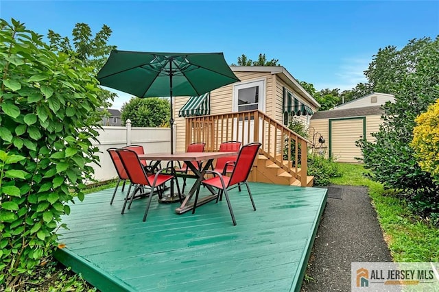 77 Navesink Ave, Middletown, NJ 07748 - wooden deck featuring outdoor dining space and a storage shed