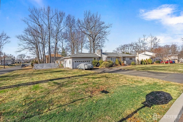 ranch-style house with a garage and a front yard