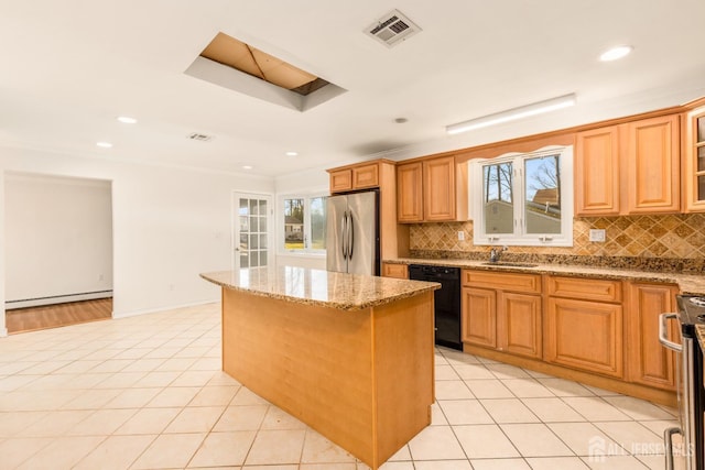 kitchen featuring a kitchen island, stainless steel refrigerator, black dishwasher, sink, and light tile patterned floors