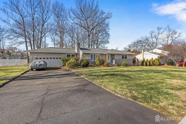 view of front of home featuring a garage and a front lawn