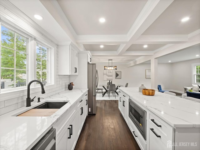 8 S Surrey Ln, East Brunswick, NJ 08816 - kitchen with stainless steel appliances, white cabinets, open floor plan, backsplash, and beamed ceiling
