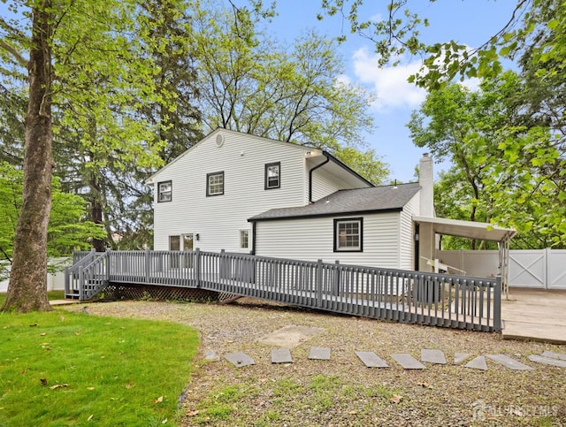 8 S Surrey Ln, East Brunswick, NJ 08816 - back of house with a wooden deck, a chimney, and a gate