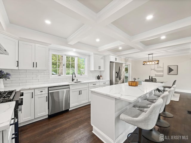 8 S Surrey Ln, East Brunswick, NJ 08816 - kitchen featuring appliances with stainless steel finishes, coffered ceiling, a center island, tasteful backsplash, and a kitchen breakfast bar