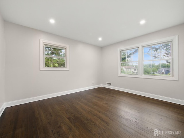 8 S Surrey Ln, East Brunswick, NJ 08816 - empty room with healthy amount of natural light, dark wood finished floors, and recessed lighting
