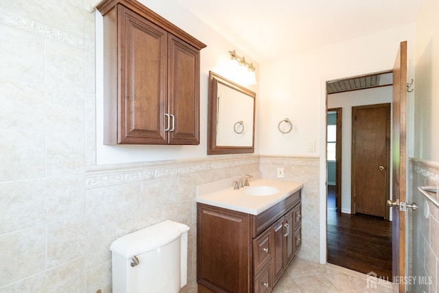 28 Beechwood Ave, Edison, NJ 08837 - bathroom featuring tile walls, vanity, tile patterned floors, wainscoting, and toilet
