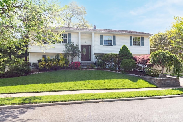 28 Beechwood Ave, Edison, NJ 08837 - raised ranch featuring a front lawn, entry steps, and a chimney