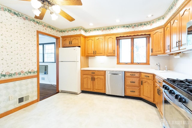 28 Beechwood Ave, Edison, NJ 08837 - kitchen featuring stainless steel appliances, wallpapered walls, light countertops, a sink, and a ceiling fan
