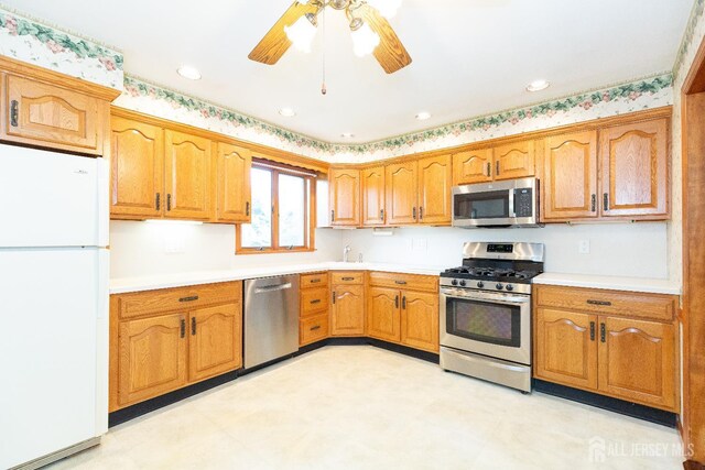 28 Beechwood Ave, Edison, NJ 08837 - kitchen with stainless steel appliances, light countertops, a ceiling fan, brown cabinets, and recessed lighting