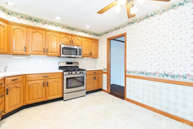 28 Beechwood Ave, Edison, NJ 08837 - kitchen featuring stainless steel appliances, wallpapered walls, a sink, a ceiling fan, and light countertops