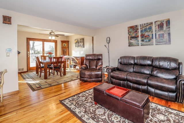 living room featuring hardwood / wood-style flooring and ceiling fan