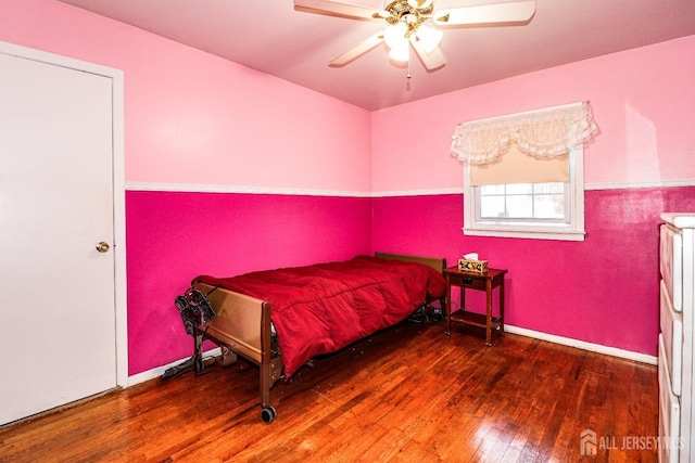 bedroom with ceiling fan and hardwood / wood-style floors