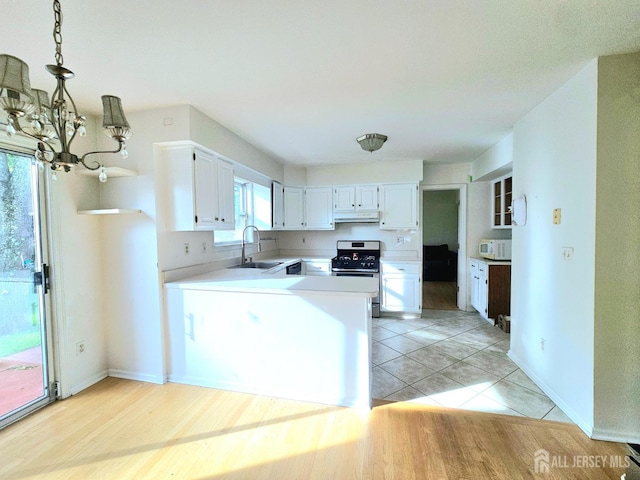 53 Perilli Dr, Hamilton, NJ 08610 - kitchen featuring stainless steel gas range oven, a sink, white microwave, under cabinet range hood, and a chandelier