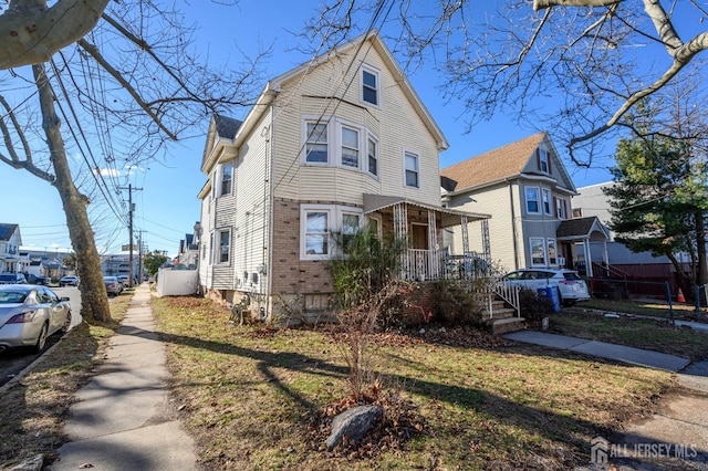 view of front of property featuring covered porch and brick siding