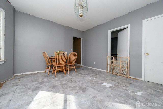 unfurnished dining area with baseboards