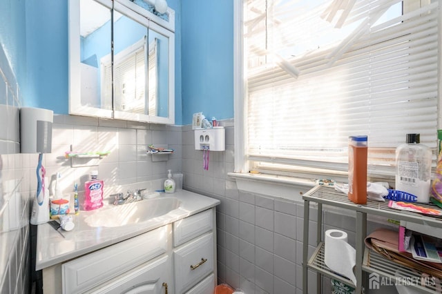 bathroom with tile walls and vanity