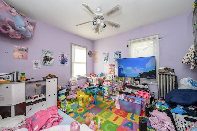 playroom featuring radiator and ceiling fan