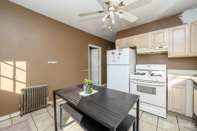 kitchen with white appliances, radiator heating unit, under cabinet range hood, and light tile patterned floors