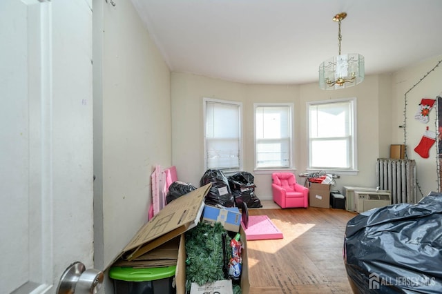 interior space with radiator heating unit and wood finished floors