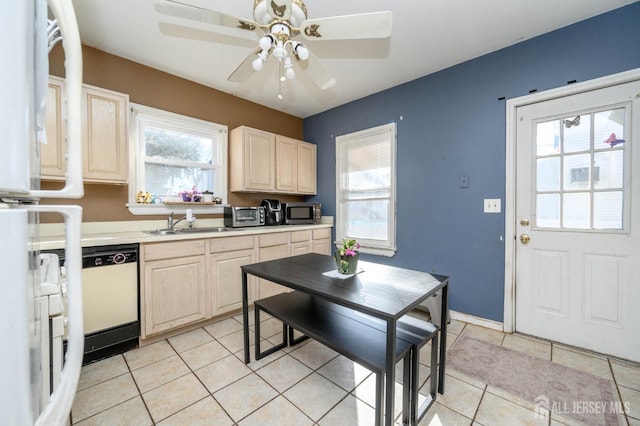 kitchen with light countertops, stainless steel microwave, plenty of natural light, and a sink