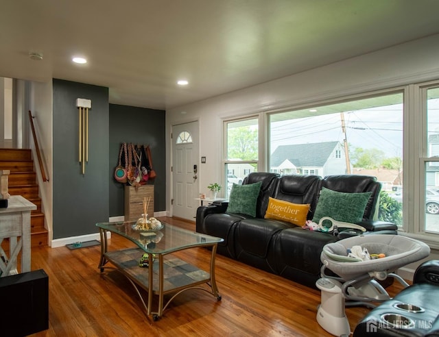 living room with stairs, wood finished floors, baseboards, and recessed lighting