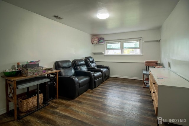 sitting room with dark wood-type flooring