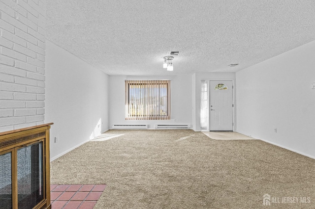 unfurnished living room featuring carpet and a textured ceiling