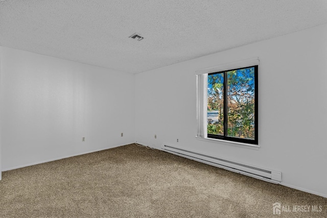 carpeted spare room featuring a textured ceiling and a baseboard heating unit