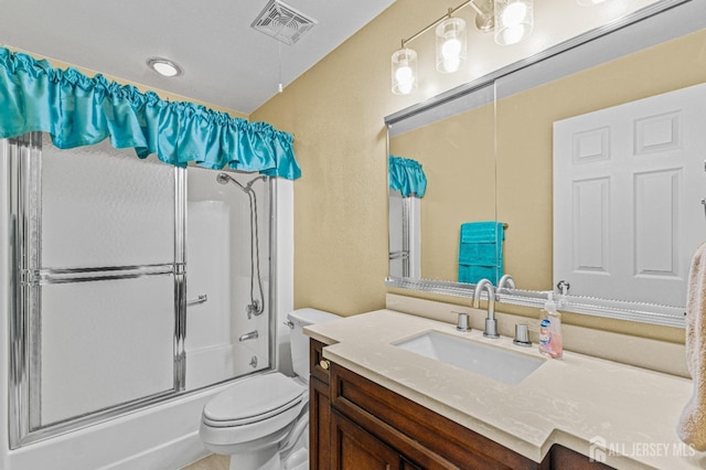 full bathroom featuring vanity, enclosed tub / shower combo, and toilet