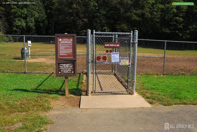 view of gate featuring a lawn