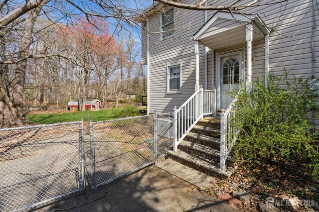entrance to property featuring fence and a gate