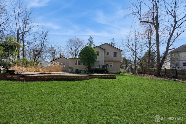 view of yard featuring fence and a wooden deck