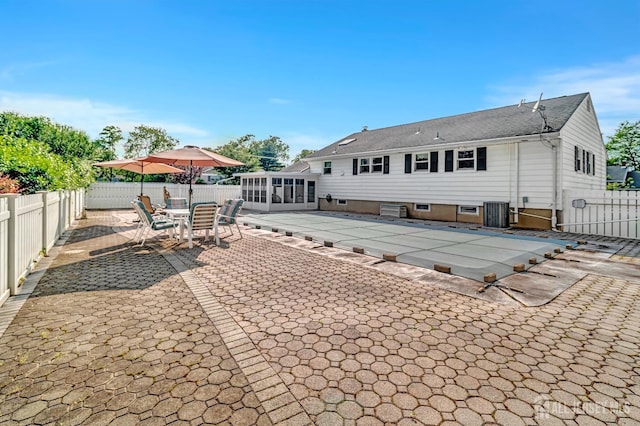 700 Sunbrite Ln, Piscataway, NJ 08854 - rear view of house with a sunroom, a patio area, and a fenced backyard