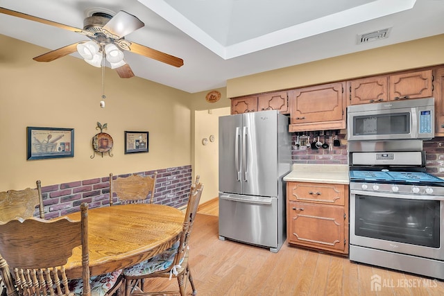 700 Sunbrite Ln, Piscataway, NJ 08854 - kitchen featuring appliances with stainless steel finishes, light countertops, decorative backsplash, and brown cabinets