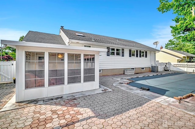 700 Sunbrite Ln, Piscataway, NJ 08854 - back of property with a sunroom, a patio area, and roof with shingles