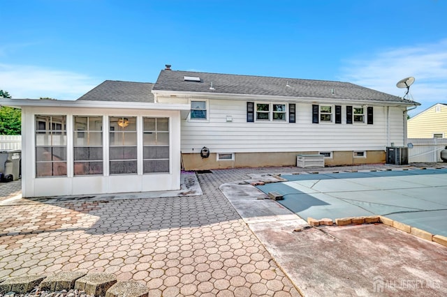 700 Sunbrite Ln, Piscataway, NJ 08854 - back of house featuring a patio, a sunroom, and roof with shingles