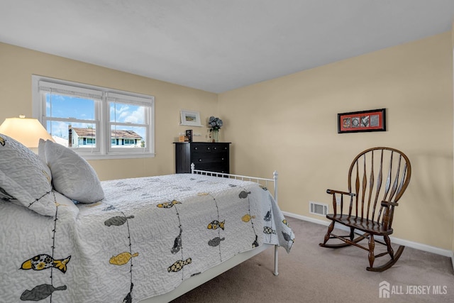 carpeted bedroom featuring baseboards and visible vents