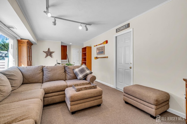 living area featuring visible vents, baseboards, carpet, and crown molding