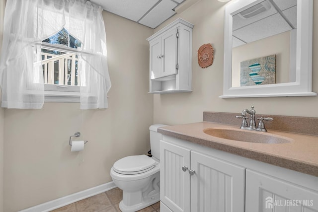 bathroom featuring visible vents, baseboards, toilet, tile patterned floors, and vanity