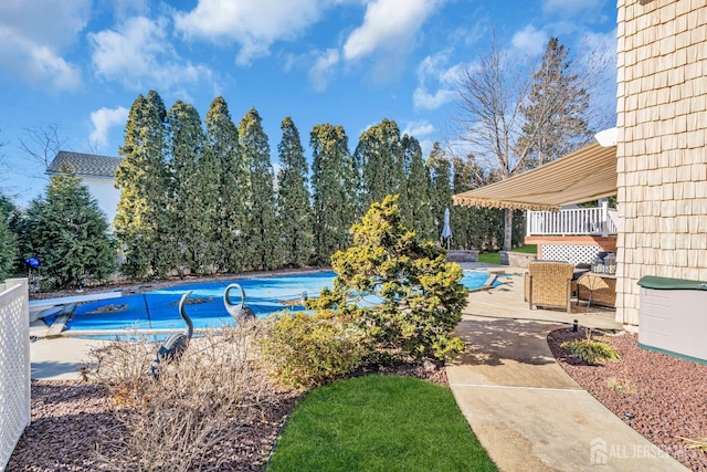 view of pool featuring a covered pool and a patio