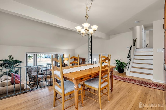 dining area with stairs, lofted ceiling with beams, light wood-style flooring, and a notable chandelier