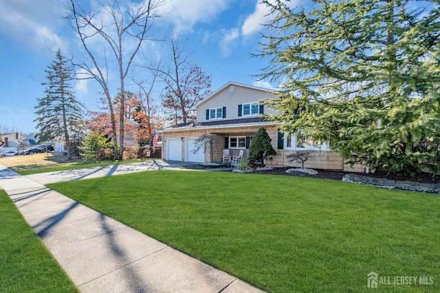 view of front of property featuring a garage, a front yard, concrete driveway, and stone siding