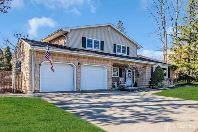 view of front of home featuring concrete driveway, an attached garage, and a front yard