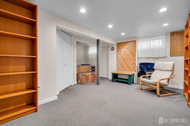 living area featuring recessed lighting, baseboards, carpet, and built in shelves